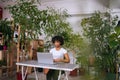 Attractive African young business woman working typing on laptop computer sitting at desk in home office room with Royalty Free Stock Photo