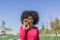 Attractive afro girl with black glasses looks with interest