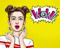 Attractive amazed young woman  with mobile phone in hand. Wow girl in comic style. Pop art woman holding smartphone. Royalty Free Stock Photo