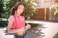 Attractive and amazing girl is looking at camera and posing. She is listening to music in headphones. Also girl is Royalty Free Stock Photo