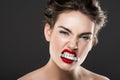 attractive angry woman holding money in teeth Royalty Free Stock Photo