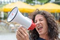 Attractive angry woman shouting into a megaphone Royalty Free Stock Photo