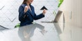 An attractive Asian businesswoman girl expressing a winning moment. Worker working on laptop at the office showing her confidence Royalty Free Stock Photo