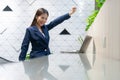 An attractive Asian businesswoman girl expressing a winning moment. Worker working on laptop at the office showing her confidence Royalty Free Stock Photo