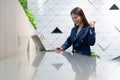 An attractive Asian businesswoman girl expressing a winning moment. Worker working on laptop at the office showing her confidence Royalty Free Stock Photo