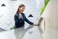 An attractive Asian businesswoman girl expressing a winning moment. Worker working on laptop at the office showing her confidence Royalty Free Stock Photo