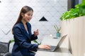 An attractive Asian businesswoman girl working with laptop at the office. showing her confidence with the work