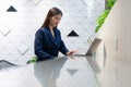 An attractive Asian businesswoman girl working with laptop at the office. showing her confidence with the work