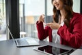 Attractive Asian businesswoman having her morning coffee at her office desk. cropped side view image Royalty Free Stock Photo