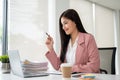 An attractive Asian businesswoman working on her business work at her desk in the office Royalty Free Stock Photo