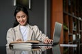 Attractive Asian businesswoman working at her desk, using laptop to manage her task Royalty Free Stock Photo