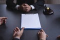 Attractive asian couple consulting a lawyer about contract agreement,blank white documents for graphic montage. Royalty Free Stock Photo