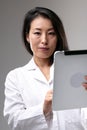 Attractive Asian doctor or nurse with clipboard Royalty Free Stock Photo