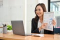 Attractive Asian female financial analyst having an online meeting with her team Royalty Free Stock Photo