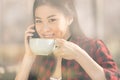 attractive asian girl using smartphone and drinking coffee in cafe coffee Royalty Free Stock Photo
