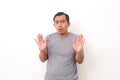 Attractive asian male shows refusal gesture, doesn`t want to participate in meeting, says: It`s not for me, leave me in piece, has