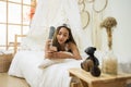 Asian girl play smartphone on bed Royalty Free Stock Photo