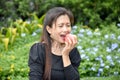 A Happy Female Senior Eating Fruit