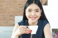 Asian Woman drinking coffee with smile on her face Royalty Free Stock Photo