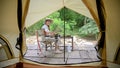 Attractive Asian woman enjoy camping alone in the beautiful wild nature campsite