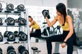 Attractive Asian woman lifting a dumbbell with dumbbell row at gym Royalty Free Stock Photo