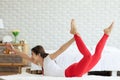 Attractive Asian woman practice yoga boat pose or Navasana pose to meditation in bedroom