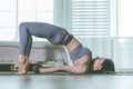 Attractive Asian woman practice yoga Half bridge pose to meditation in bedroom after wake up in the morning