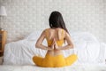 Attractive Asian woman practice yoga lotus pose to meditation in bedroom Royalty Free Stock Photo