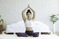 Attractive Asian woman practice yoga lotus pose to meditation in bedroom Royalty Free Stock Photo