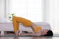 Attractive Asian woman practice yoga pose to meditation in bedroom