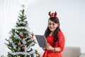 Woman in red dress using tablet on christmas Royalty Free Stock Photo