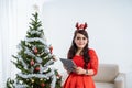 Woman in red dress using tablet on christmas Royalty Free Stock Photo