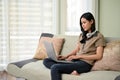 Attractive Asian woman remote working from home, using laptop computer Royalty Free Stock Photo