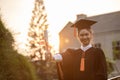 Attractive Asian Women Student Graduate in cap and gown celebrating with certificate in hand and so proud happiness Royalty Free Stock Photo