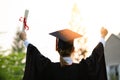 Attractive Asian Women Student Graduate in cap and gown celebrating with certificate in hand and so proud happiness Royalty Free Stock Photo