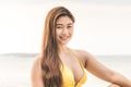 Attractive Asian young woman wearing bikini smile enjoy with summer vacation on the beach feeling so happiness and cheerful Royalty Free Stock Photo