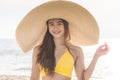 Attractive Asian young woman wearing yellow bikini smile enjoy with summer vacation on the beach feeling so happiness Royalty Free Stock Photo