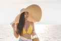 Attractive Asian young woman wearing yellow bikini smile enjoy with summer vacation on the beach feeling so happiness Royalty Free Stock Photo