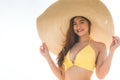 Attractive Asian young woman wearing yellow bikini smile enjoy with summer vacation on the beach feeling so happiness Royalty Free Stock Photo