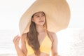 Attractive Asian young woman wearing yellow bikini smile enjoy with summer vacation on the beach feeling so happiness Royalty Free Stock Photo