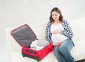 Attractive awaiting woman packing children's clothes Royalty Free Stock Photo