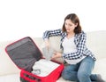 Attractive awaiting woman packing children's clothes Royalty Free Stock Photo