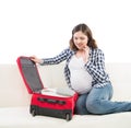 Attractive awaiting woman packing children`s clothes Royalty Free Stock Photo