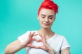 Attractive awesome girl making a heart gesure