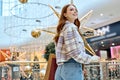 attractive awesome red-haired girl visits mall