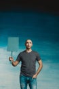 Attractive bald man in a T-shirt with a protest poster in his hands