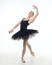 Attractive ballerina stands on her fingertips. photo shoot in the studio on a white background