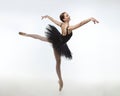 Attractive ballerina stands on her fingertips. photo shoot in the studio on a white background