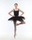 Attractive ballerina stands on her fingertips. photo shoot in the studio on a white background