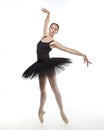 Attractive ballerina stands on her fingertips. photo shoot in the studio on a white background